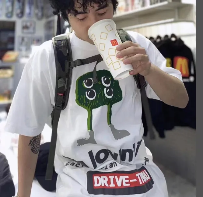 ￥109 CPFM.  McDonald's collaborates on a four eyed monster logo foam printed short sleeved t-shirt