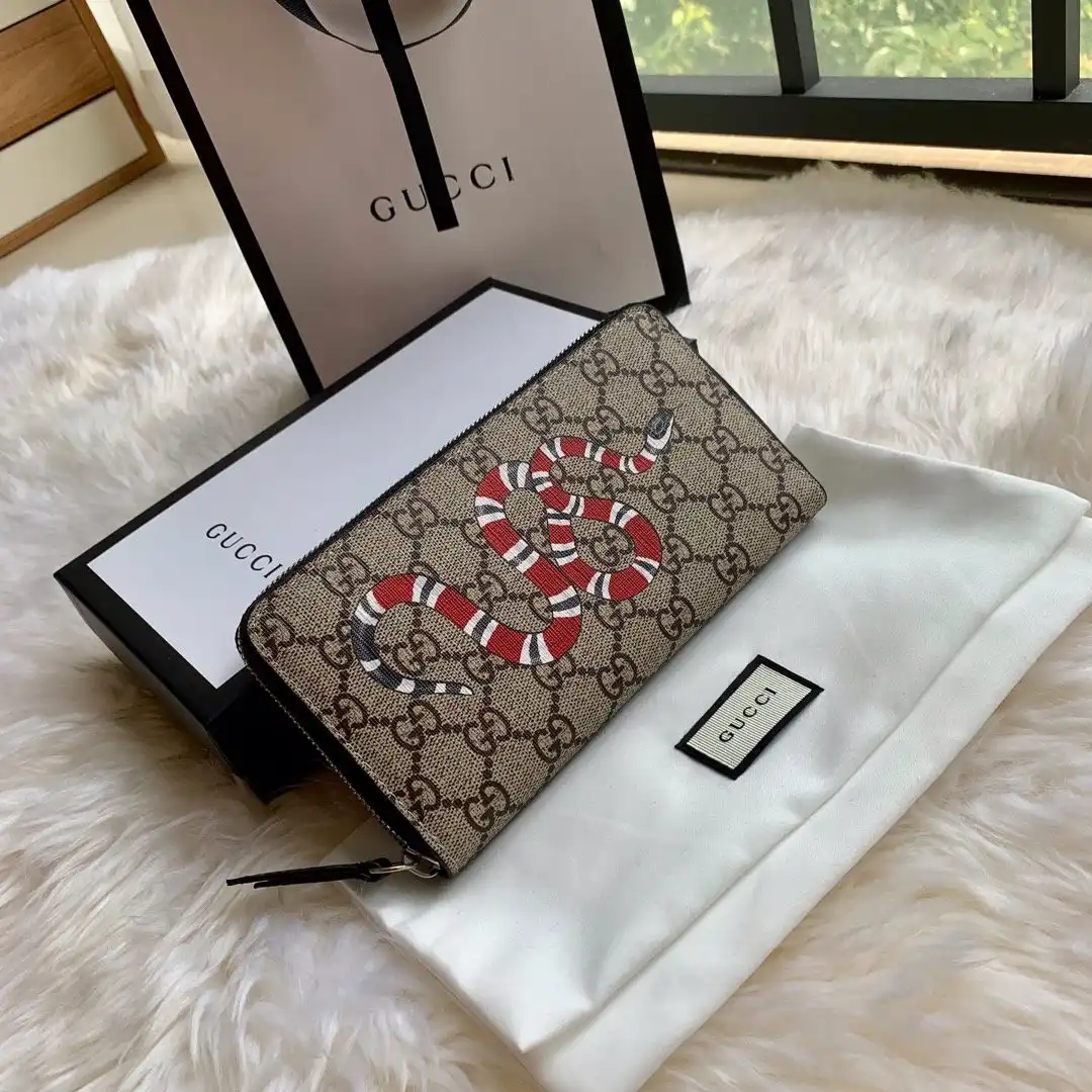 First bag ru GUCCI Bee print GG zip around wallet