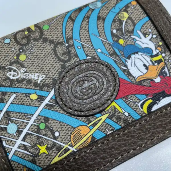 First bag ru Disney x Gucci Donald Duck card case wallet