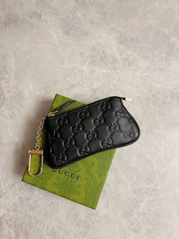 First bag ru Gucci Signature key case