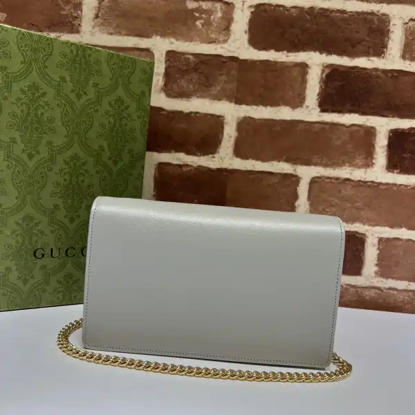 First bag ru Gucci Chain wallet with Gucci script