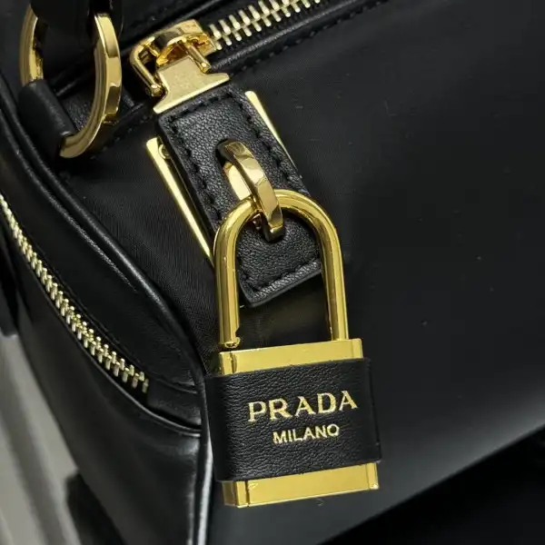 First bag ru Prada Medium Re-Nylon shoulder bag with padlock