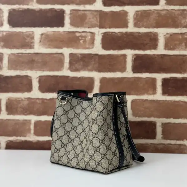 First bag ru Gucci GG Emblem mini bucket bag